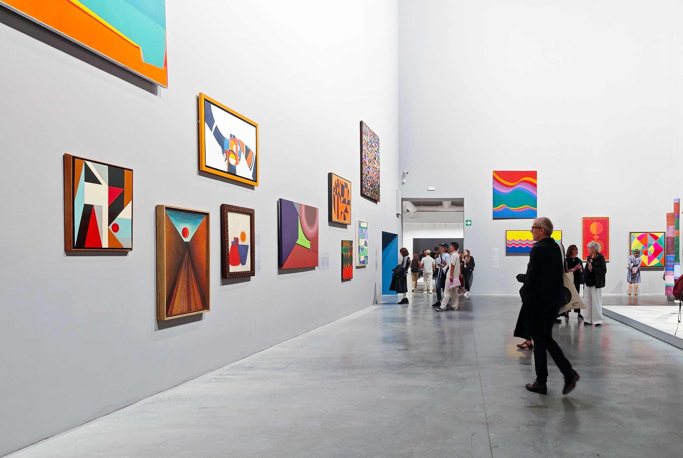 Venice Biennale, visitors admiring paintings in the room dedicated to the abstraction of 37 artists at the central Pavilion inside the Gardens.