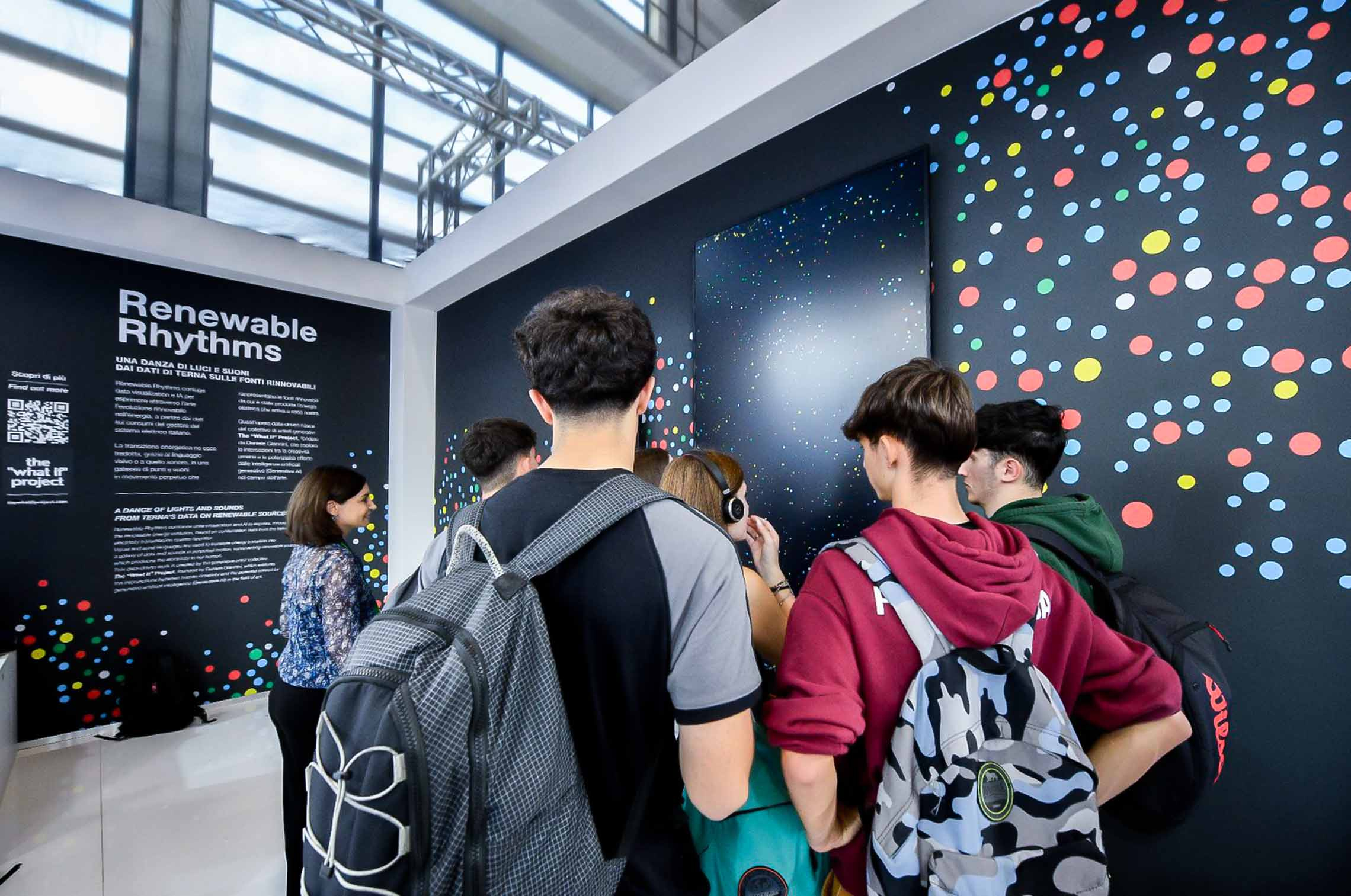 People standing in front of the Renewable Rhythms’ exhibitions dashboard