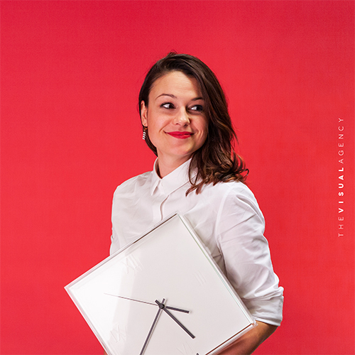 Nina Corradini is the Sales and Marketing Director. She is holding a minimalist clock, proving that time is money.