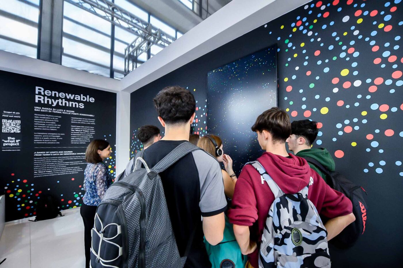 A photo shows students visiting the exhibition and looking at a data painting monitor