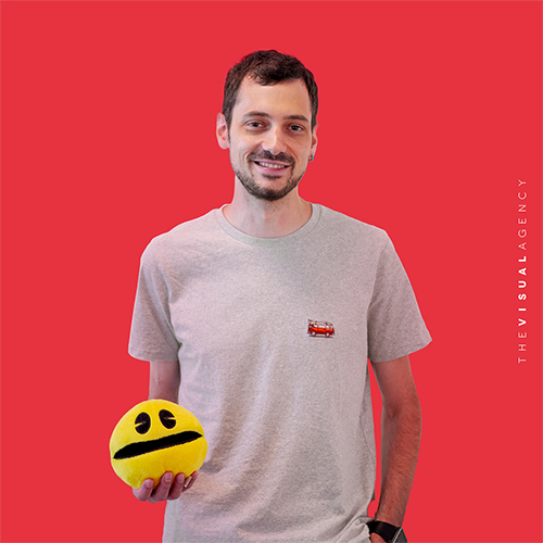 Matteo Losi is a Senior Front-end Developer. He's holding a yellow puppet as if it were his debugging consultant.