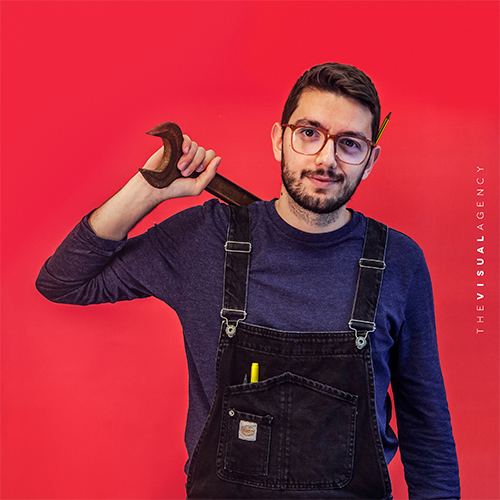 Valerio Palmerini is a Motion Designer and Illustrator. He's holding tools and wearing a salopette, as if he's building animations from the ground up.