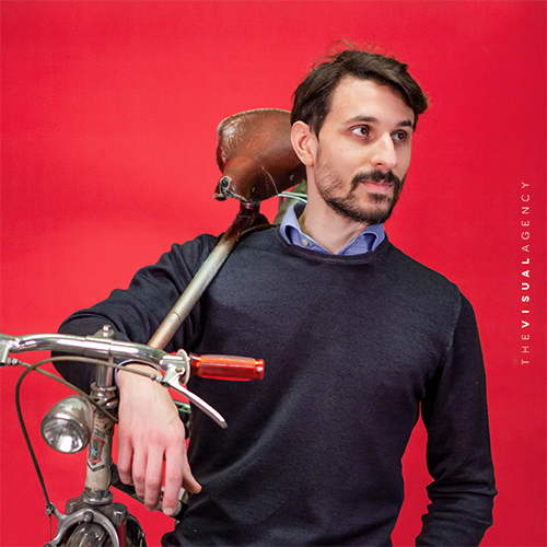 Francesco Roveta is the Chief Operating Officer. He carries a vintage bike over his shoulder, ready to hit the road.