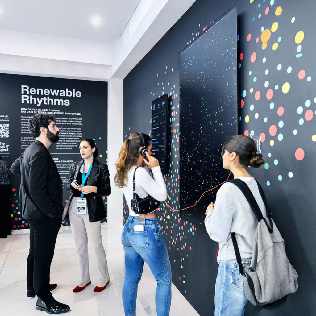 People engaging with an interactive art installation titled "Renewable Rhythms" at an exhibition.